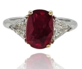 18kt white and yellow gold oval ruby and trillion diamond ring