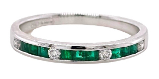 18kt white gold emerald and diamond channel set band.