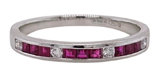 18kt white gold ruby and diamond channel set band.