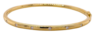 14kt yellow gold bangle bracelet with burnish set diamonds.