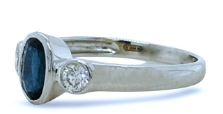 18kt white gold bezel set sapphire and diamond 3 stone ring
