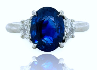 18kt white gold oval sapphire and diamond 3-stone ring.