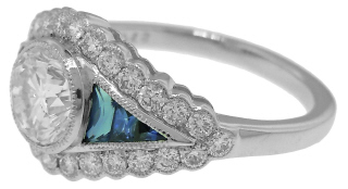 Platinum round diamond and calibre sapphire engagement ring