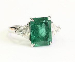 Platinum emerald cut emerald and trillion diamond ring
