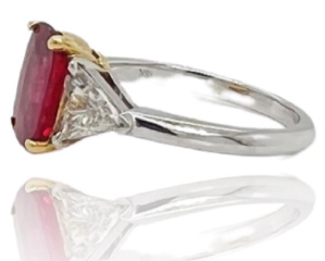 18kt white and yellow gold cushion ruby and trillion diamond ring