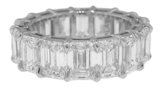 Platinum shared prong emerald cut diamond eternity band with airline.