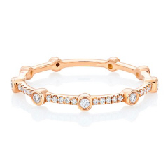 14kt rose gold diamond band with bezel set diamonds.