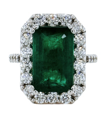 Platinum emerald cut emerald and diamond halo ring