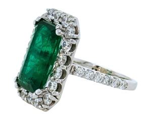 Platinum emerald cut emerald and diamond halo ring