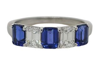 18kt white gold emerald cut sapphire and diamond band.