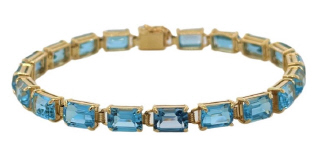 14kt yellow gold emerald cut blue topaz bracelet.