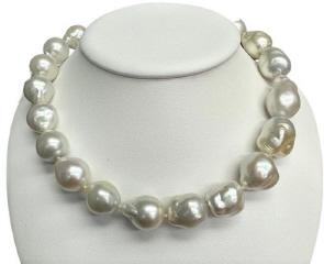 Strand of barouque south sea pearl necklace with 18kt yellow gold diamond swirl clasp