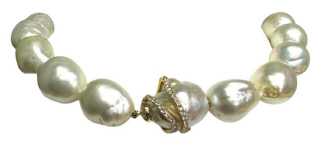 Strand of barouque south sea pearl necklace with 18kt yellow gold diamond swirl clasp