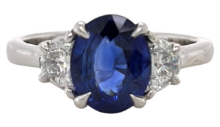 Platinum oval sapphire and half moon diamonds ring