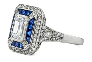 Platinum emerald cut diamond center with round diamonds and sapphires ring