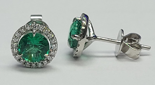 18kt white gold emerald and diamond halo stud earrings.