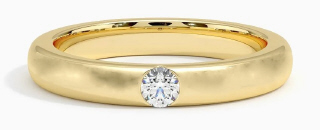 14kt yellow gold 3.25mm band with burnish set diamond.