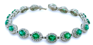 18kt white gold oval emerald and diamond bracelet.