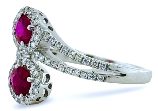 18kt white gold ruby and diamond cross over ring.