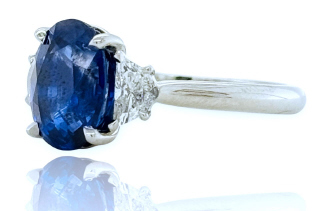 18kt white gold oval sapphire and diamond 3-stone ring.