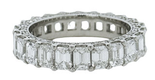 Platinum emerald cut diamond eternity band with pave set diamonds on the side