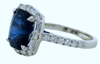 18kt white gold cushion cut sapphire and diamond halo style ring.