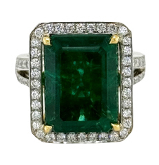 18kt two tone emerald cut emerald and diamond halo ring.
