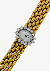 Ladies 18kt yellow gold 7" Quartz bracelet watch with diamonds and MOP diamond dial.