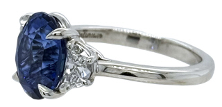 Platinum oval sapphire and half moon diamond 3-stone ring