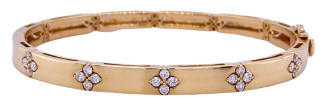 14kt yellow gold bangle bracelet with clover diamond motifs.