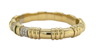 18kt two tone emerald and diamond flex cuff bangle bracelet.