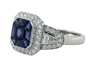 18kt white gold invisible set sapphire ring with diamonds.