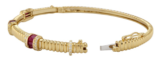 14kt yellow gold fluted style ruby and diamond bangle bracelet.