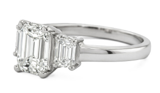 Platinum three stone emerald cut diamond ring