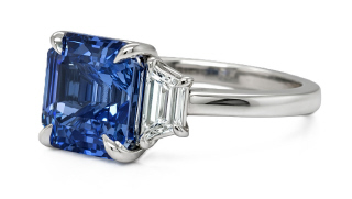 Platinum square emerald cut sapphire and trap diamond three stone ring