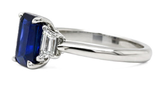 Platinum emerald cut sapphire and traps diamond ring