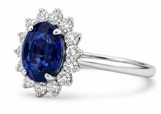 Platinum oval sapphire and diamond halo style ring.